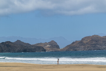 A Women walking along a wild beach on S&atilde;o Vicente island, Cape Verde