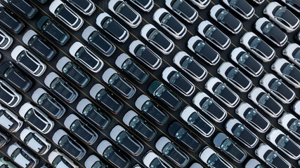 Aerial view car for sale stock lot row, Cars dealership inventory distribution automobile and automotive business, New cars parking for sale automobile automotive industry business.