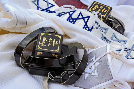Traditional Jewish prayer items including tefillin and tallit arranged on a table