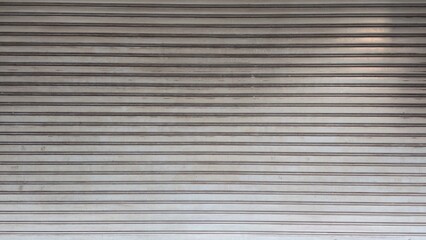 Rolling door. Steel shutter door of warehouse. The shutters are gray metal. Steel rolling shutter background. Silver metal rolling shutter background. Background images and texture images.