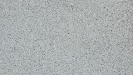 Fototapeta premium Grey sandblasted granite stone texture background. Fine speckled texture of a sandblasted grey granite surface. Ideal for architectural backgrounds, construction materials, and minimalist designs.