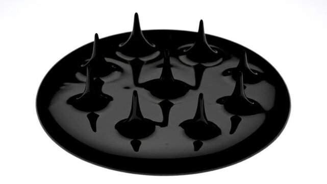 Black circular object with sharp spikes on its surface.