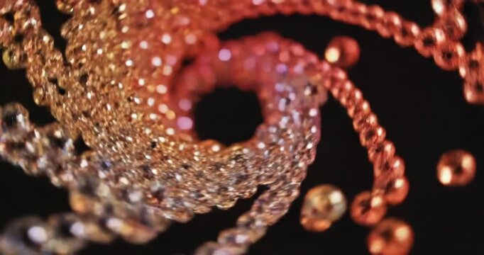 Colorful spiral of reflective beads creating a mesmerizing pattern against a dark background