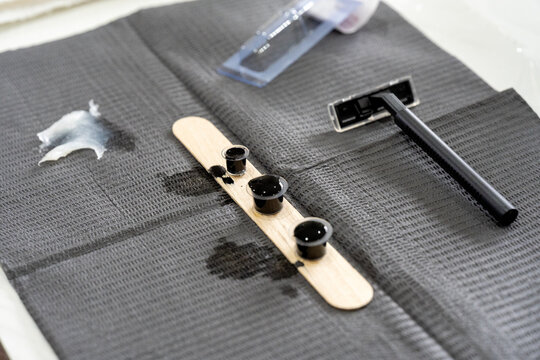 Tattoo tools on grey textured cloth