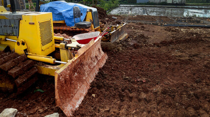 Heavy machinery at work on a construction site with bulldozer clearing muddy terrain, viewed from a close-up perspective, capturing the industrial activity and rugged environment like in IMG_4389 (1) © Belva