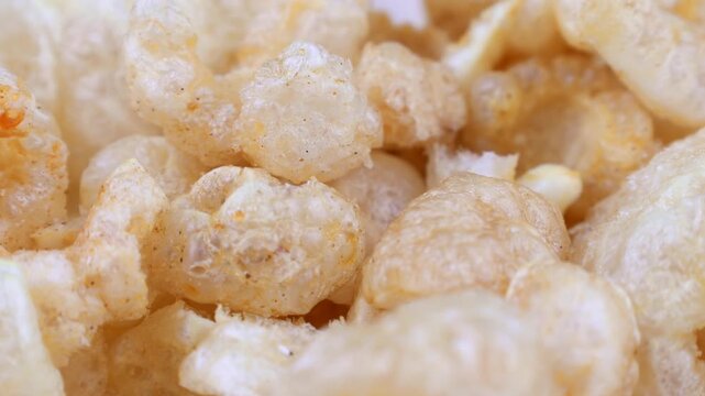 Deep fried chicharron or chicharrones pork rinds circle rotation close up