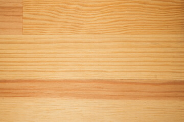 Close-up of a light wooden board with visible natural grain and soft warm tones. Horizontal wood texture background suitable for design, product presentation, mockups, packaging, branding and interior