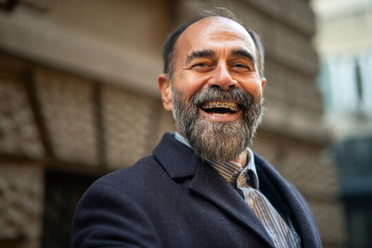 Mature man smiling widely showing dental braces