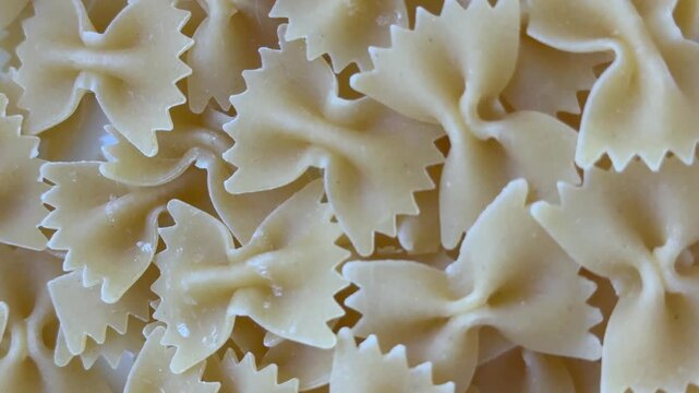Rotating close-up of farfalle pasta, organic Italian food against a backdrop of culinary design, healthy eating, and marketing concepts