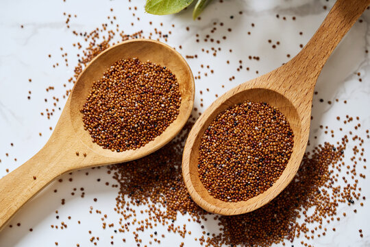 flat lay canihua seed or baby quinoa in wood spoon on white background