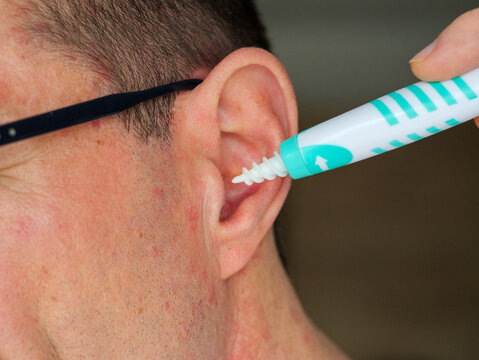 Man Using Spiral Ear Cleaner Tool Close Up