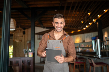 Proud cafe owner standing confidently behind the counter, ready to serve customers with a warm smile