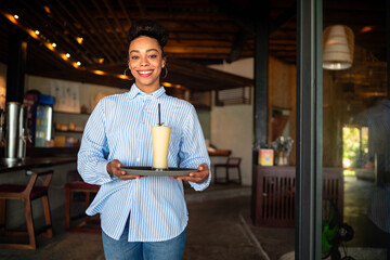 Smiling waitress at a cafe, showcasing friendly customer service, welcoming hospitality atmosphere