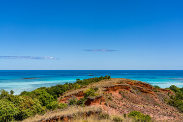 tropical beach and sea from red cliff