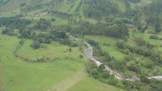 drone view of a river in the middle of the mountains in salento, colombia, the coffee region of colombia
