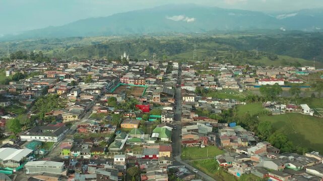 drone overlooking the small city of filandia, from the outside of the city to the main plaza incluiding church n colonial buildins in the plaza, very completed video