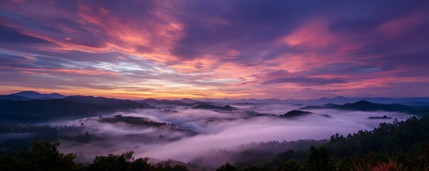 Early morning viewpoint with dramatic sunrise sky and fog-covered landscape