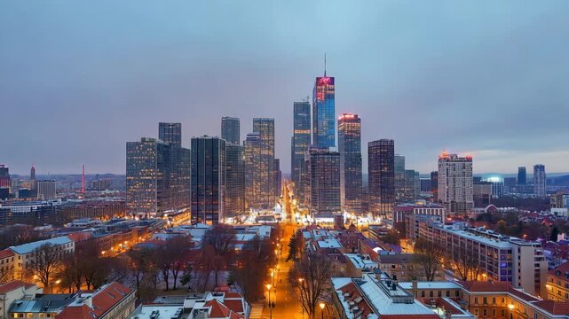 Wide city skyline weather timelapse at dusk with illuminated buildings, long streets, and cool evening tones, illustrating urban life, architecture, and modern metropolitan energy
