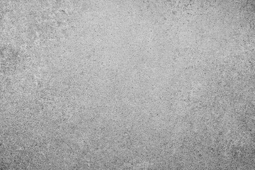 Obraz premium Rough gray speckled concrete surface textured background showing many small dark particles evenly spread