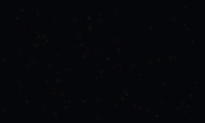 Fototapeta premium Sparkling golden embers float in darkness creating a magical, festive atmosphere.