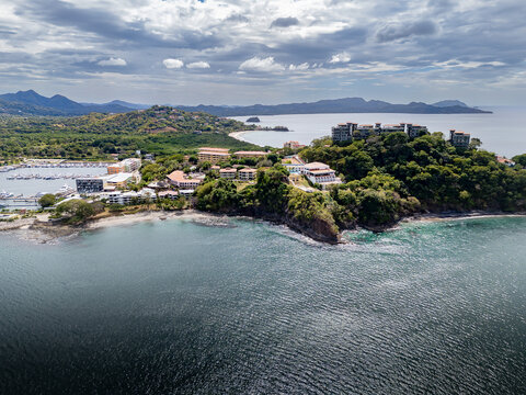 Aerial Playa Flamingo along the Pacific coast of Guanacaste Costa Rica overlooking luxury villas marina and sandy beach coastline.
