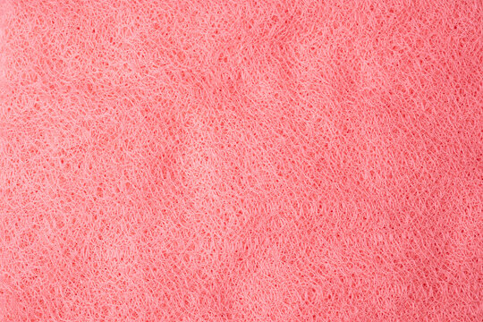 Full frame close up abstract background of tangled vibrant pink synthetic scrubbing pad texture material
