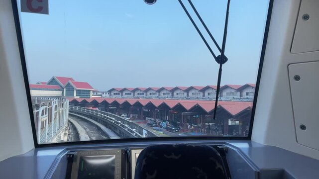 Elevated Monorail View of Modern Airport Terminal and Urban Infrastructure