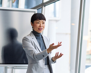 Fototapeta premium Group of young business people having a meeting or presentation and seminar with digital display whiteboard in the office. Portrait of a young businesswoman leader