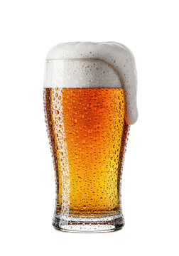 ultra-sharp, low-angle shot of a sweating, overflowing nonic pint glass filled with golden lager and thick white microfoam against a transparent background, concept for beverage advertising