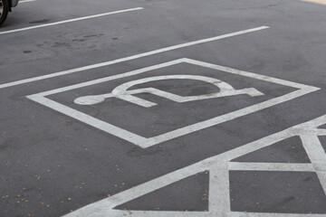 A parking lot with a handicap parking sign
