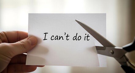 Hand holding paper with text being cut by scissors cutting 1