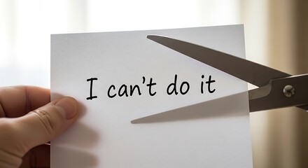 Hand holding paper with text being cut by scissors cutting