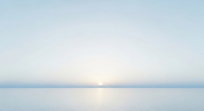 Sunrise over calm ocean horizon with soft golden light and clear blue sky minimalist seascapes