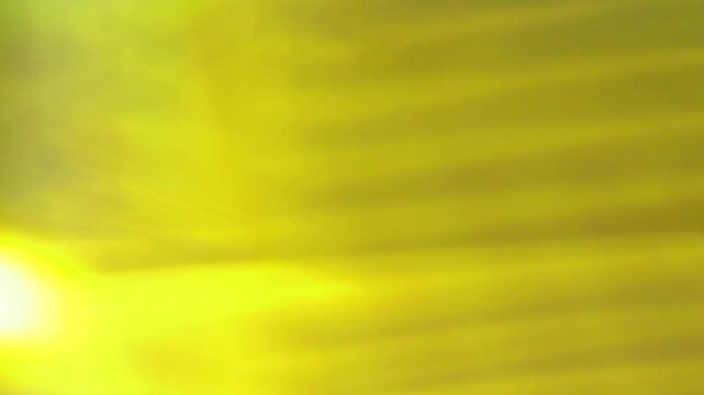 Vintage Light film burn Transition. Energetic yellow and brown abstract background with light flares and dark moments.