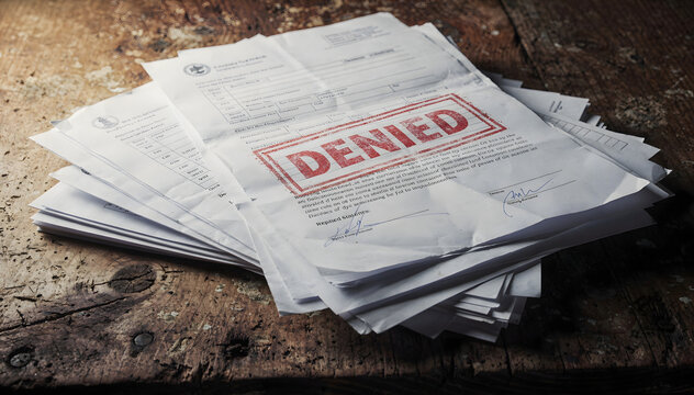 Stack of Documents Marked Denied on Rustic Wood Surface: Rejection, Failure, and Bureaucracy Concepts with Paperwork and Negative Outcome, High Angle View