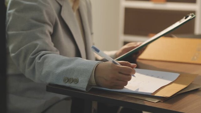 Legal advisor is explaining the offense under the law in the book at office.