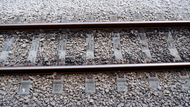 Top View of Railway Tracks with Concrete Sleepers and Grey Stone Ballast