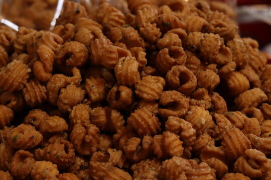 A Large Pile of Crispy Thai Fried Flour Cookies (Krong Krang Krop) Glazed with Sweet and Spicy Caramel.