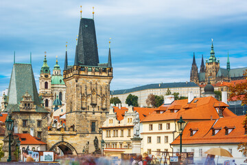 Fototapeta premium Charles Bridge (Karlův most) in Prague, Czech Republic, spanning the Vltava River with historic towers and Gothic architecture. Panoramic view of the medieval bridge and city skyline, iconic European 