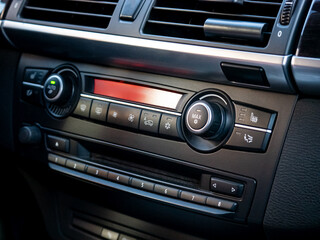 Obraz premium Close up of an automotive dashboard showing climate control and radio navigation system in a new modern car for transportation design