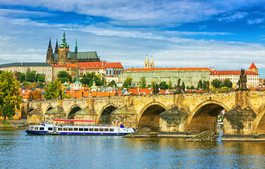 Fototapeta premium Charles Bridge (Karlův most) in Prague, Czech Republic, spanning the Vltava River with historic towers and Gothic architecture. Panoramic view of the medieval bridge and city skyline, iconic European 