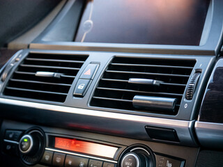 Obraz premium Car dashboard with air conditioning vents and climate control panel. Automobile interior detail showing heating and ventilation system.