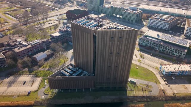 Futuristic data center tower in Amsterdam, aerial establishing shot of modern, inovative computing center