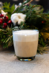 Coffee with festive decor. Creamy latte surrounded by seasonal embellishments and glow