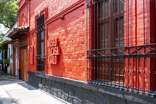 Mexico City, Mexico - October 7, 2025: The vibrant red facade of the new Museo Casa Kahlo, letters mounted on textured brick wall, symbolizing strong cultural identity artistic legacy under daylight