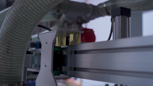 Industrial robot arm moving along a linear guide rail