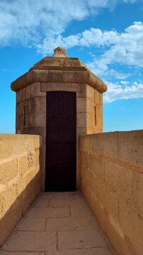 Stone watchtower on the walls of Santa Barbara Castle. Garita de la Campana stone sentry box on a fortification wall under a blue sky.
