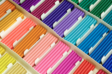 Pieces of multi-colored plasticine in a cardboard box