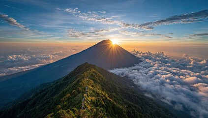 Majestic mountain peak rising through clouds with sunrise in background