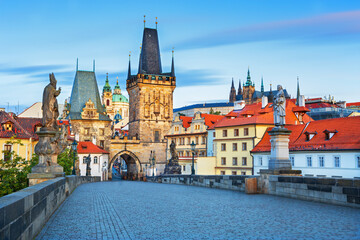 Fototapeta premium Charles Bridge (Karlův most) in Prague, Czech Republic, spanning the Vltava River with historic towers and Gothic architecture. Panoramic view of the medieval bridge and city skyline, iconic European 